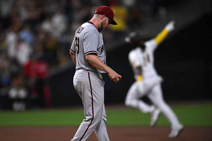 Merrill Kelly watches as Josh Bell rounds the bases after hitting a home run.